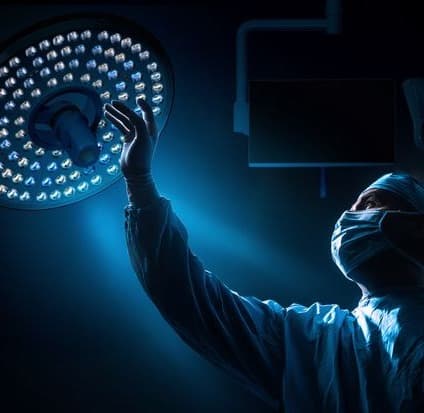Surgical team under an operating lamp