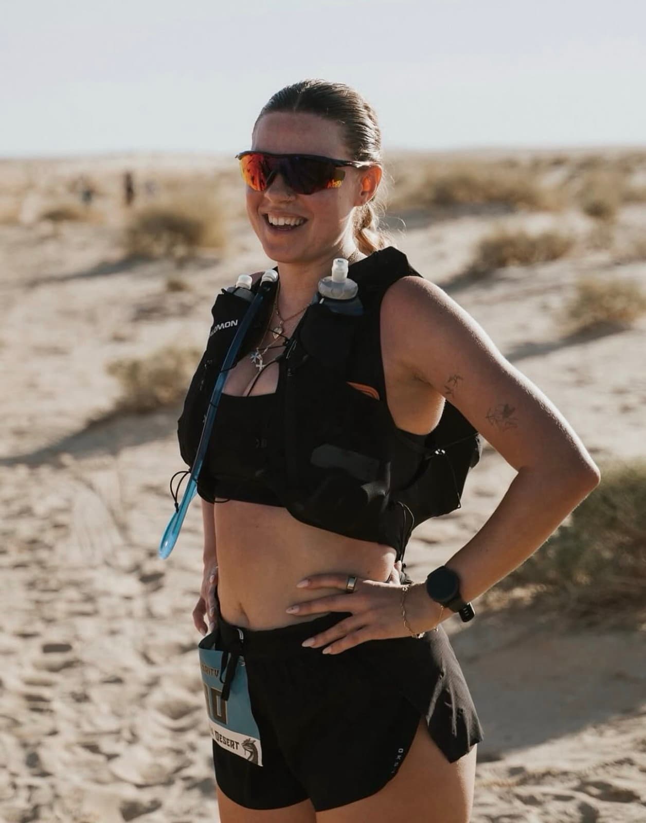 Jasmin in a running vest on a desert trail